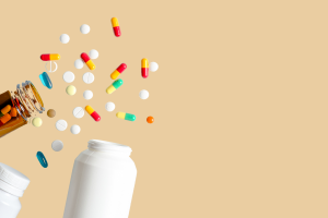picture of open pill bottles with pills spill out
